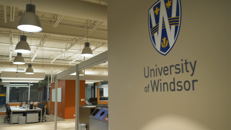 Video still of wall with University of Windsor logo